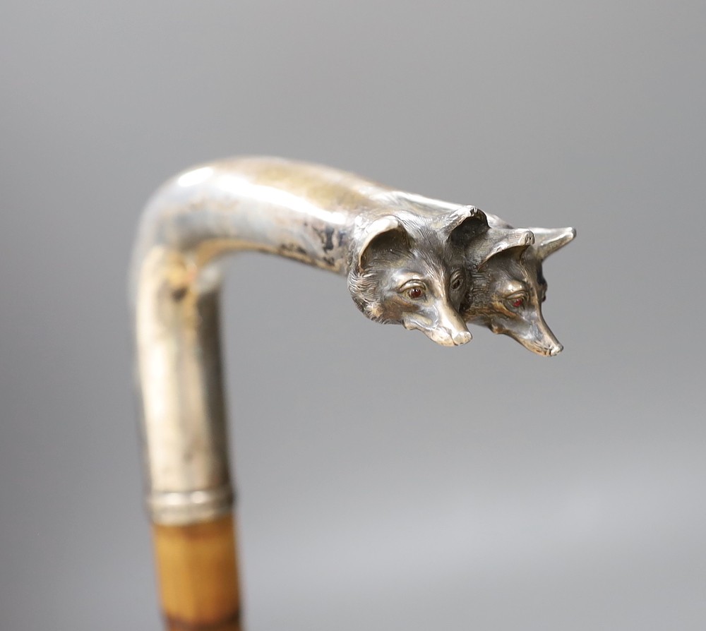 An early 20th century Austro-Hungarian white metal mounted double fox head walking cane, 89 cms long